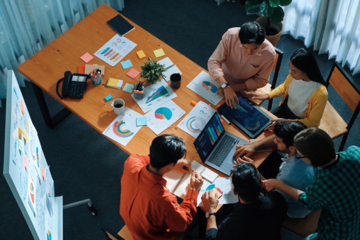 Team collaborating on a social media strategy plan to support business growth